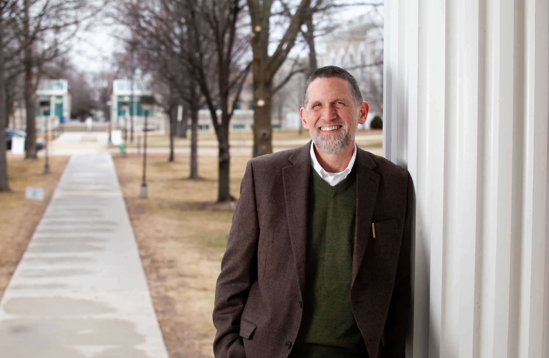 Peter Peregrine stands in front of Main Hall.