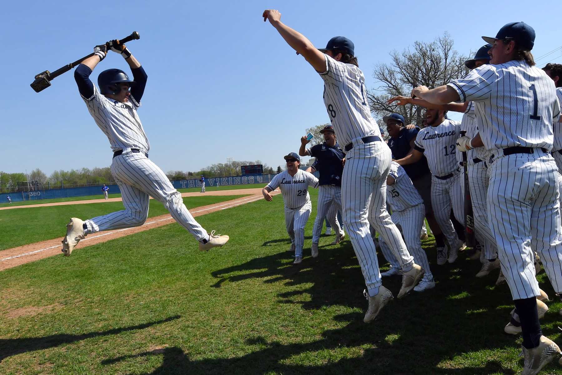 Lawrence players celebrate a home run during the Midwest Conference Tournament.