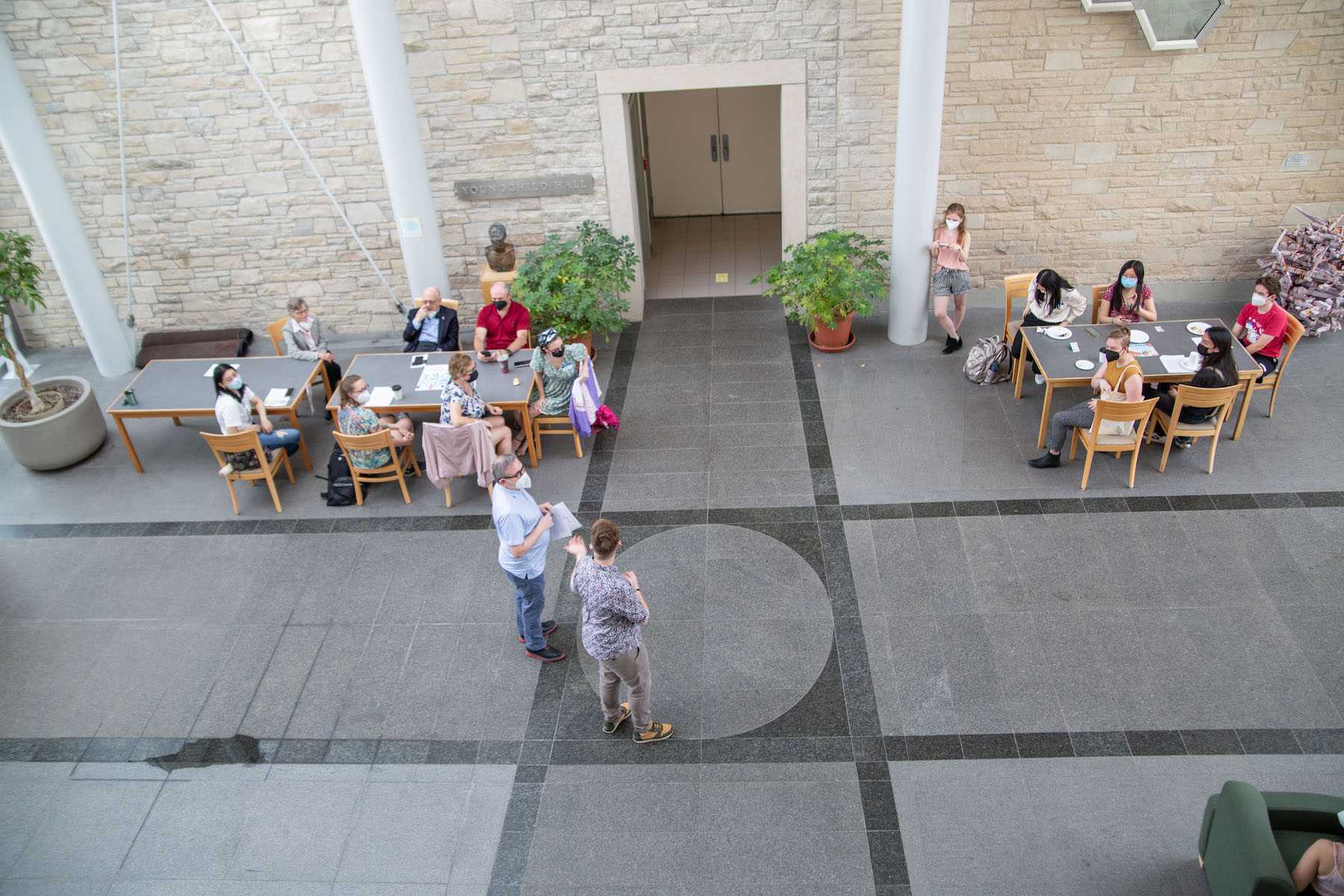 Peter Blitstein and Connie Kassor speak to Harrison Symposium participants in the Youngchild atrium before presentations begin. 