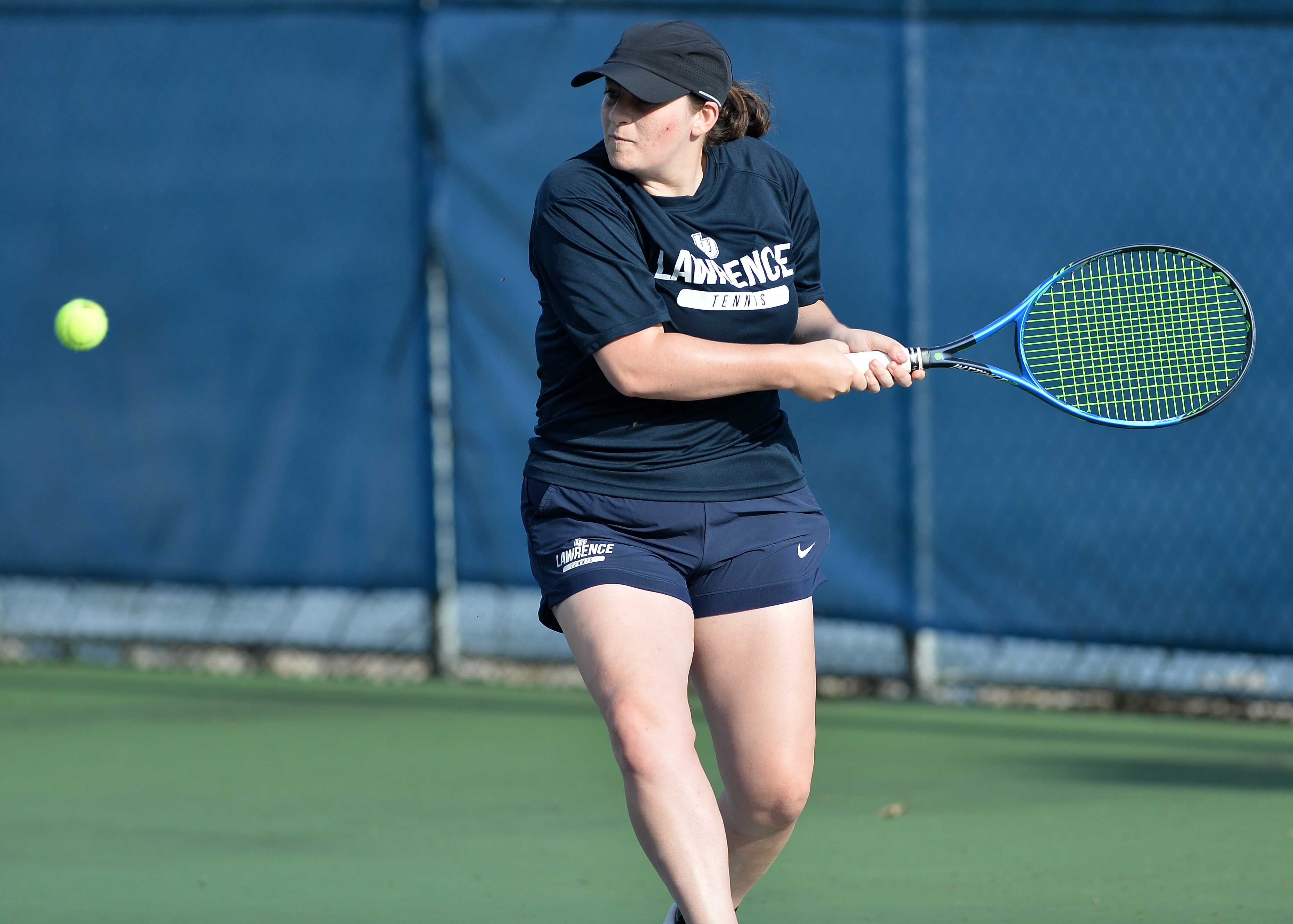 Lizzy Angemi hits a backhand during a tennis match.