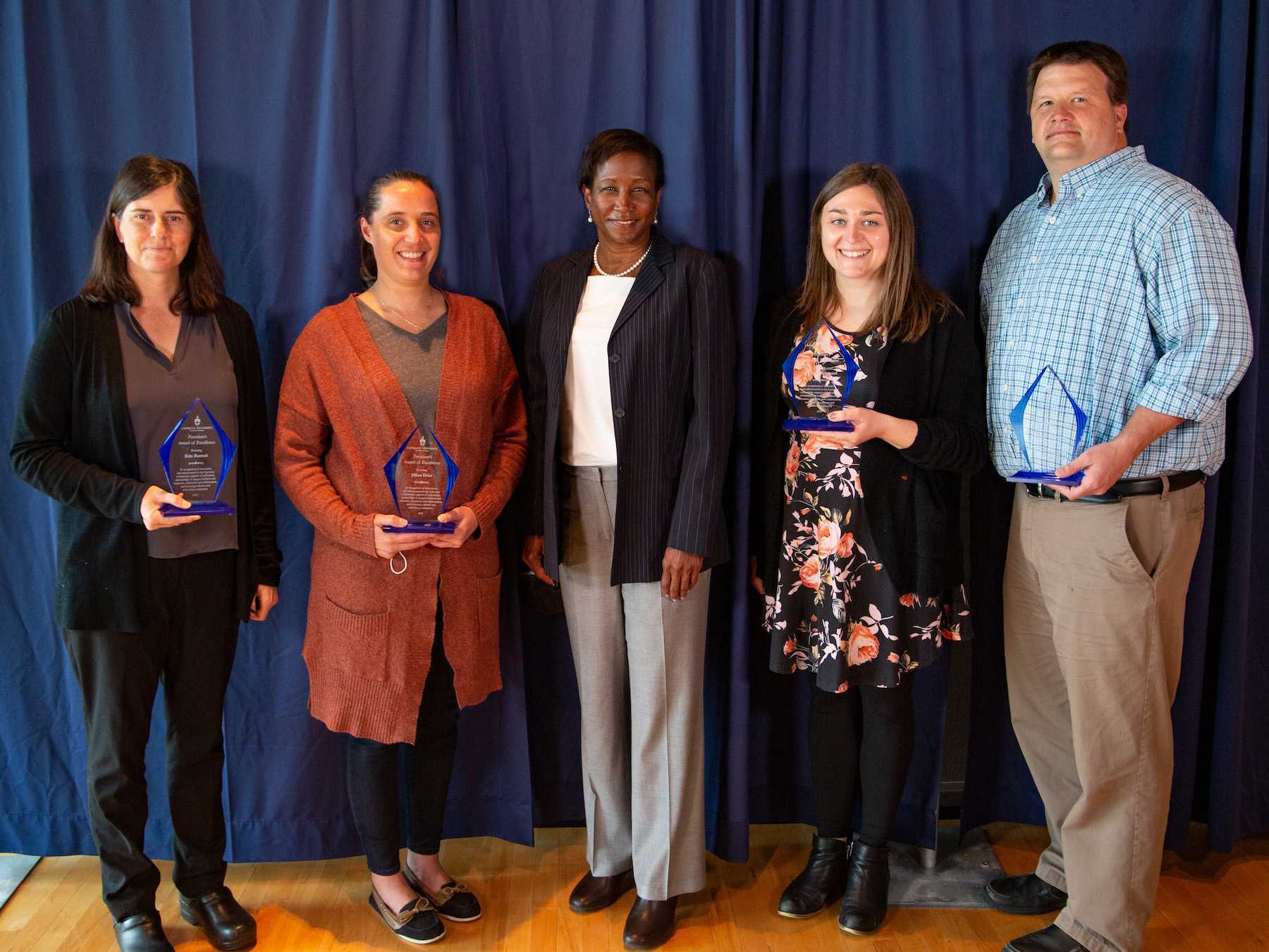Erin Buenzli, Jillian Drier, Rich Jazdzewski, and Lindsey Wyngaard pose for a photo with President Laurie A. Carter following the Service Awards luncheon.