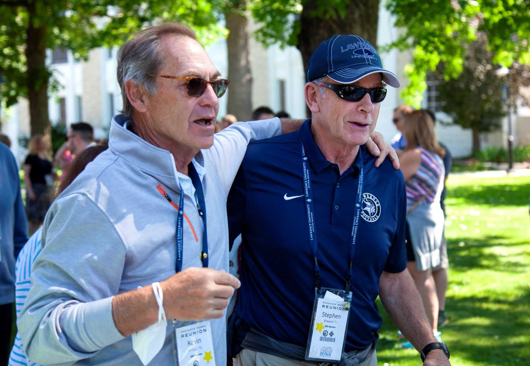 Kevin Phillips ’72 and Stephen Shepard ’72 walk with their arms around each other during the Parade of Classes. 