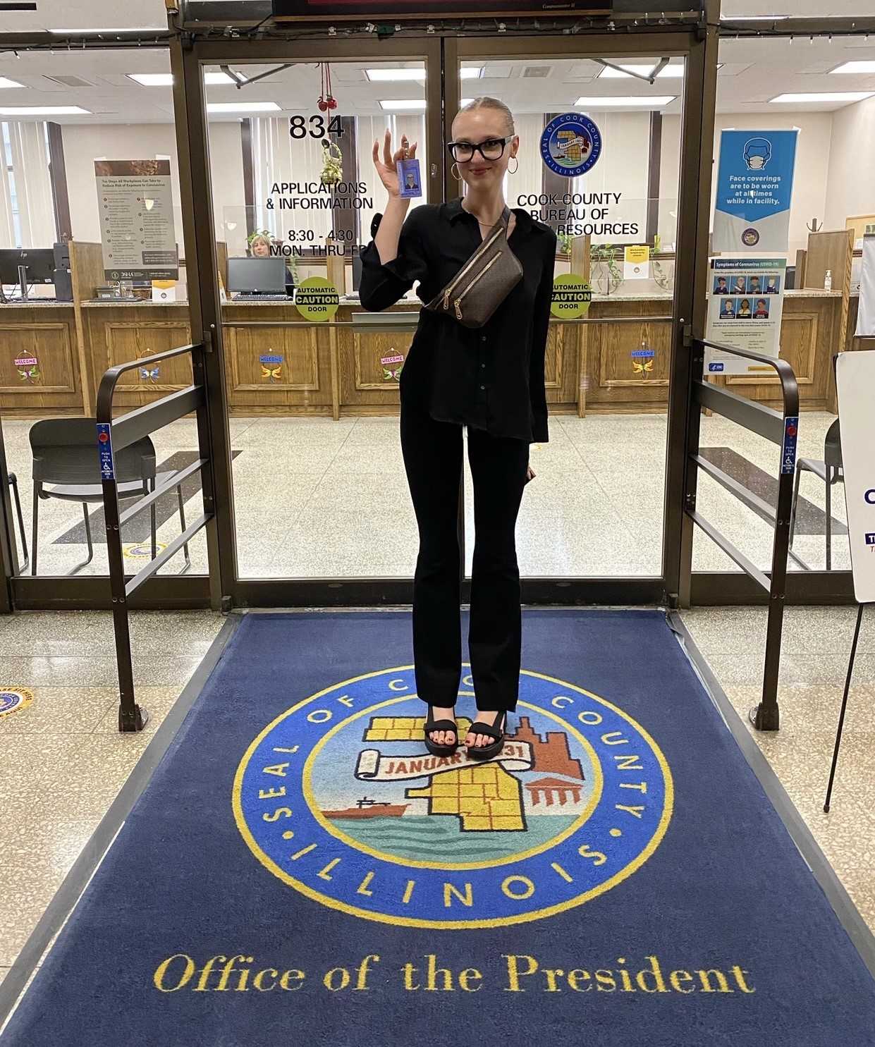 Delilah Rose poses for a photo in the doorway of her workplace.