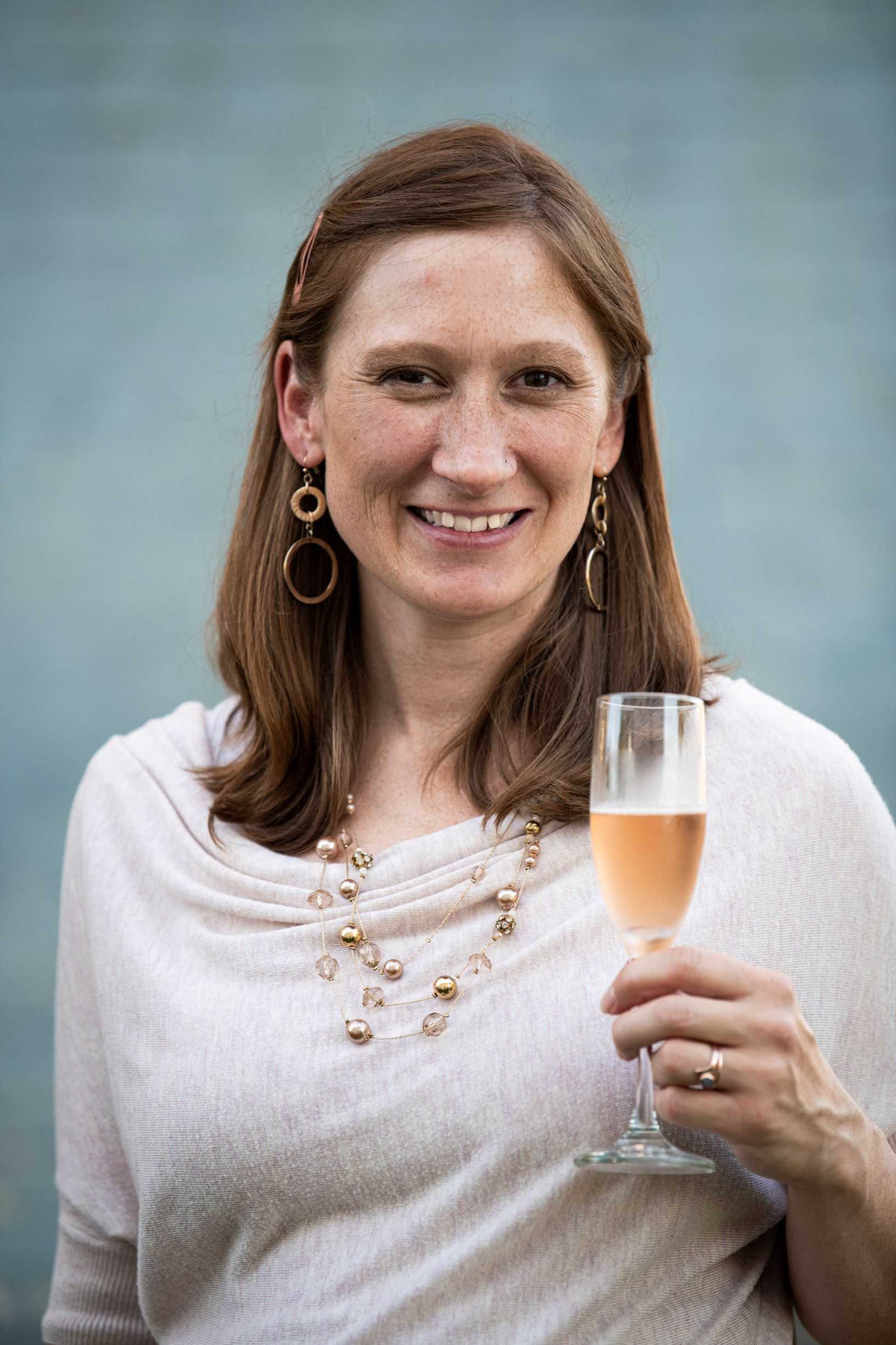 Josie Boyle holds a glass of wine.