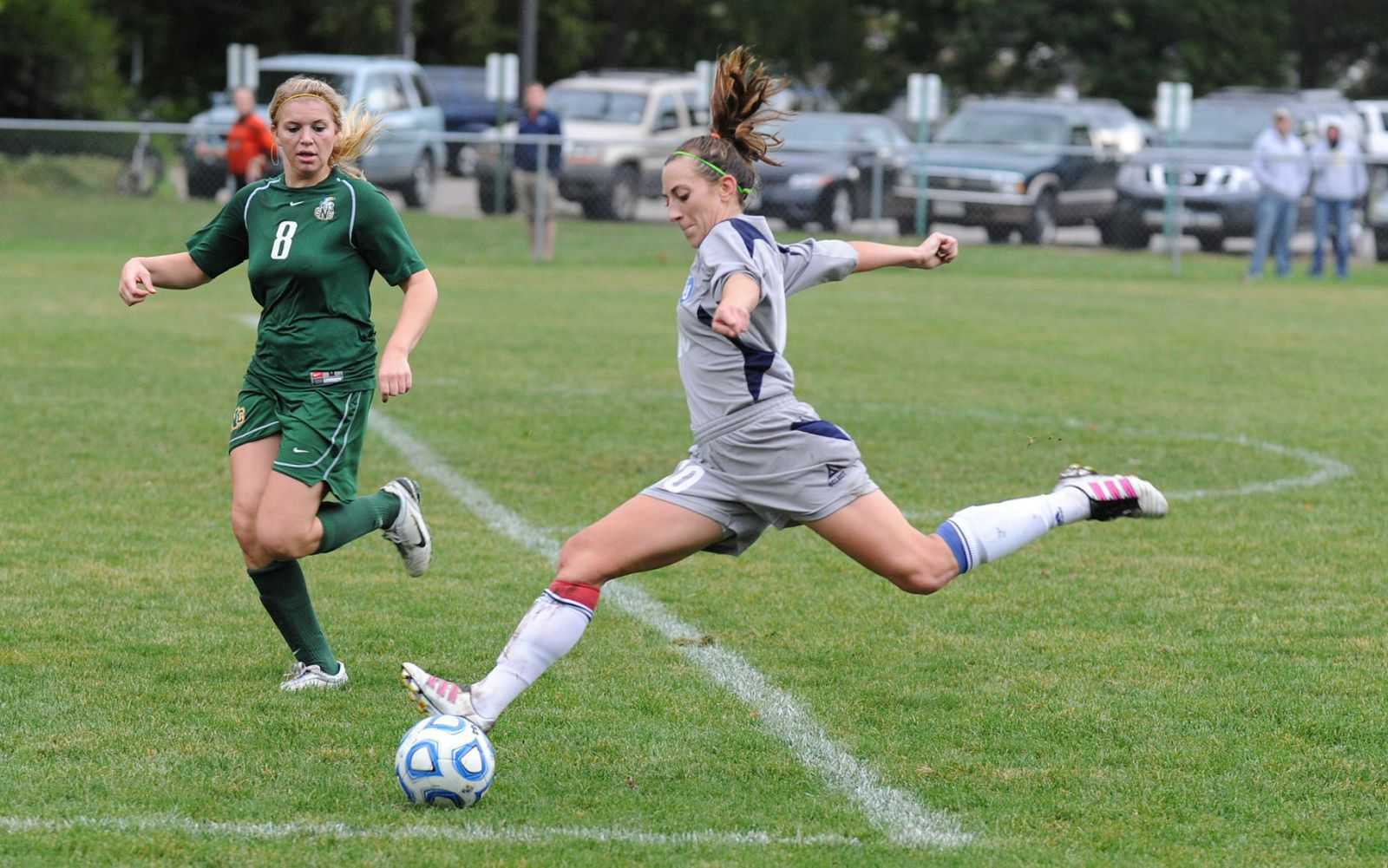 Mallory Koula kicks the ball during a women's soccer game.