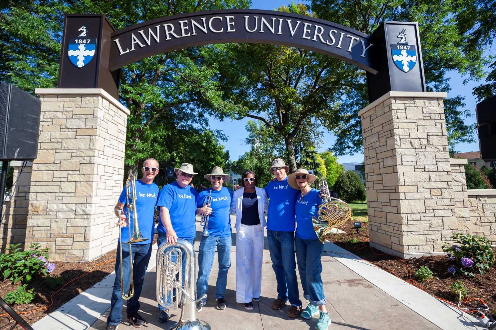 President Laurie Carter poses with the musicians at the Welcome Arch reveal.