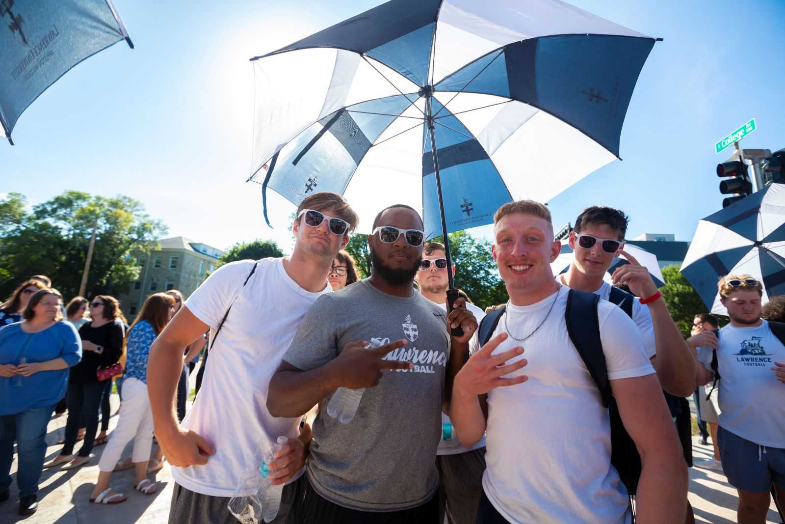 A group of students pose for a photo during the Welcome Arch unveiling.