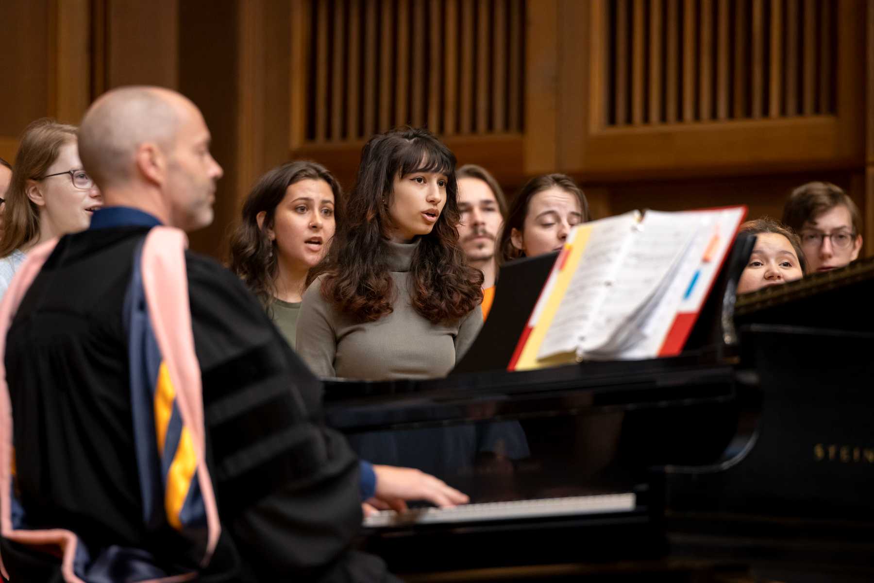 Stephen Sieck plays the piano as he leads the Welcome Week Choir in a performance during the convocation.