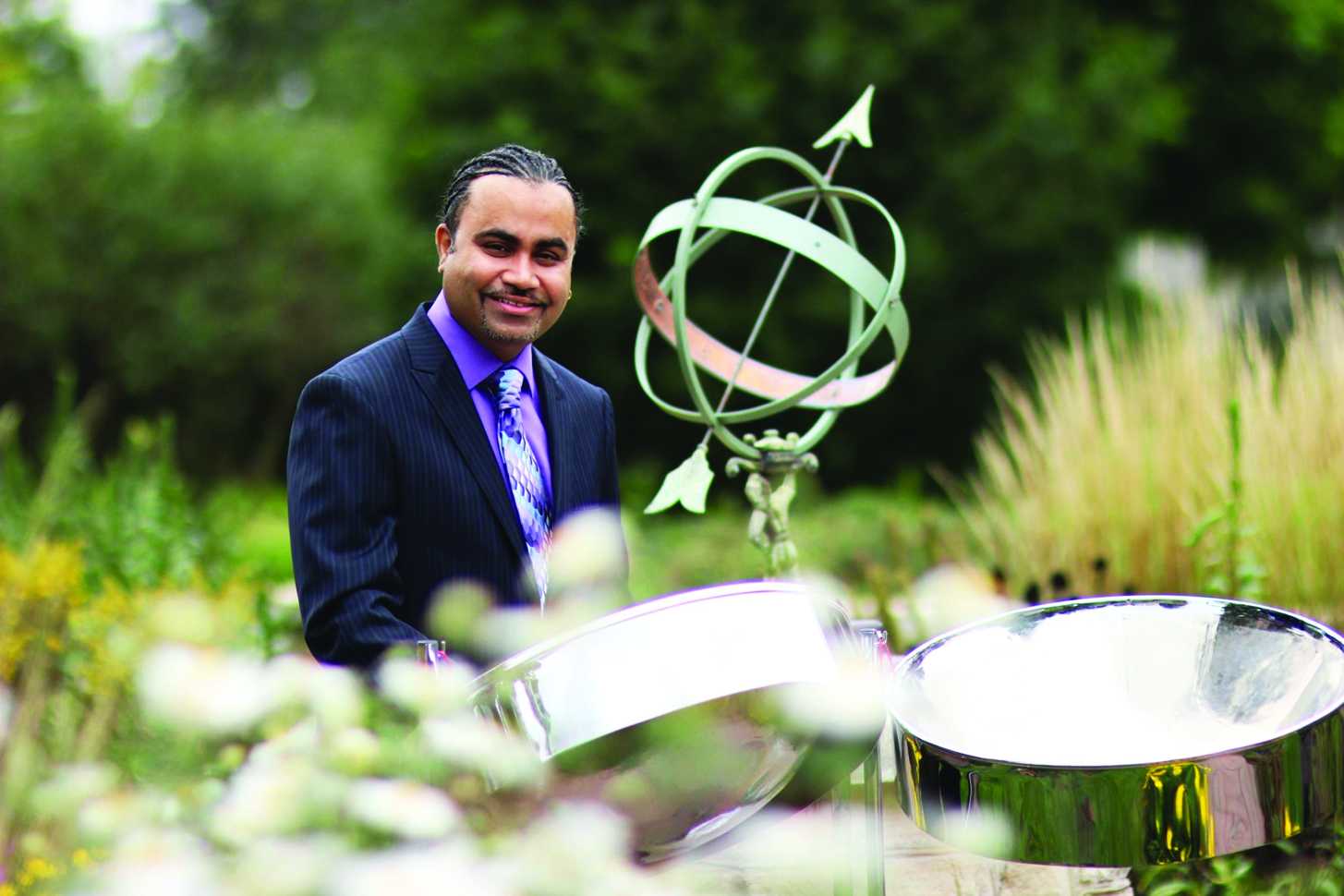 Portrait of Liam Teague outdoors with steelpan set.