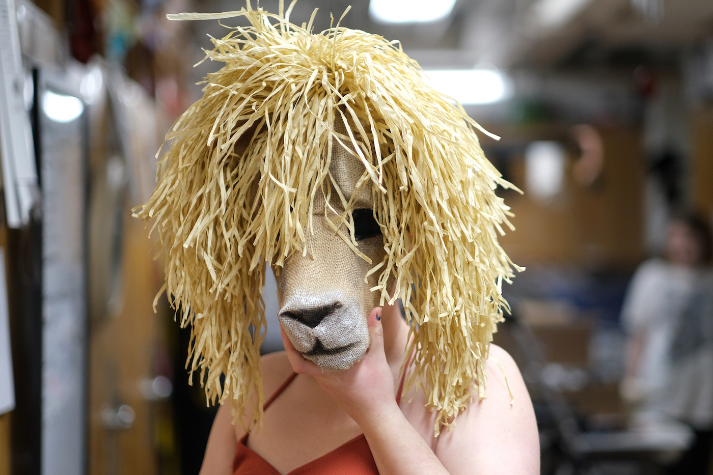 A student wears an animal mask in preparation for "Alcina."