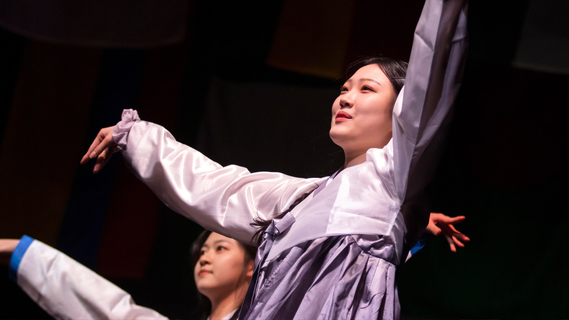 Asian students dancing in traditional attire during Cabaret