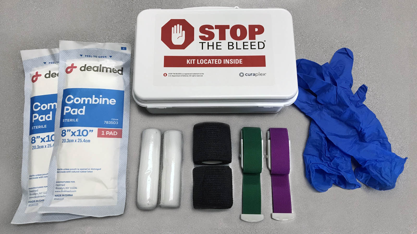 Stop the Bleed Kit contents - latex-free gloves, 2 quick-release tourniquets, 2 wraps, 2 gauze rolls, and 2 combine pads
