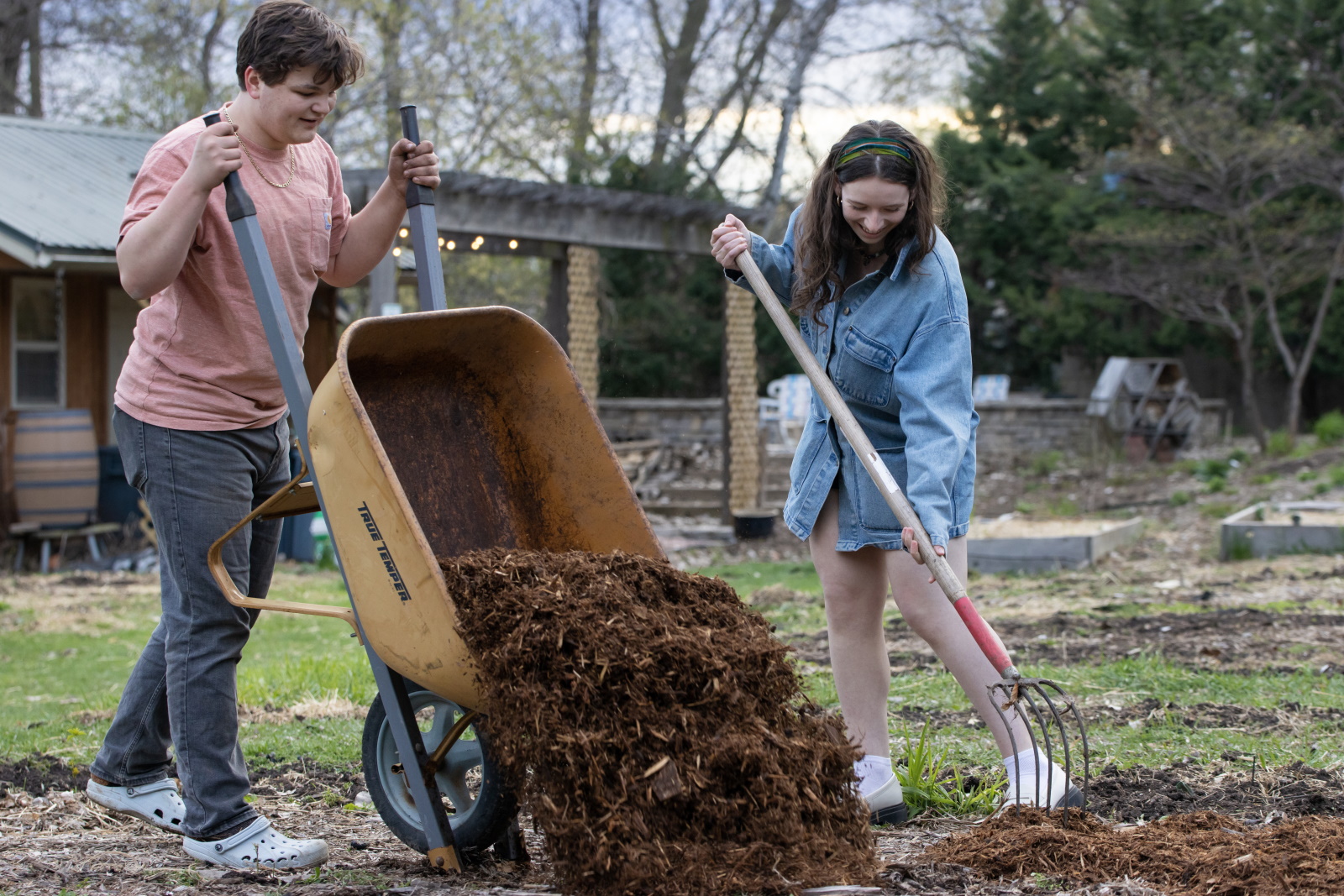 Anders Hanhan and another student spread mulch in SLUG. 