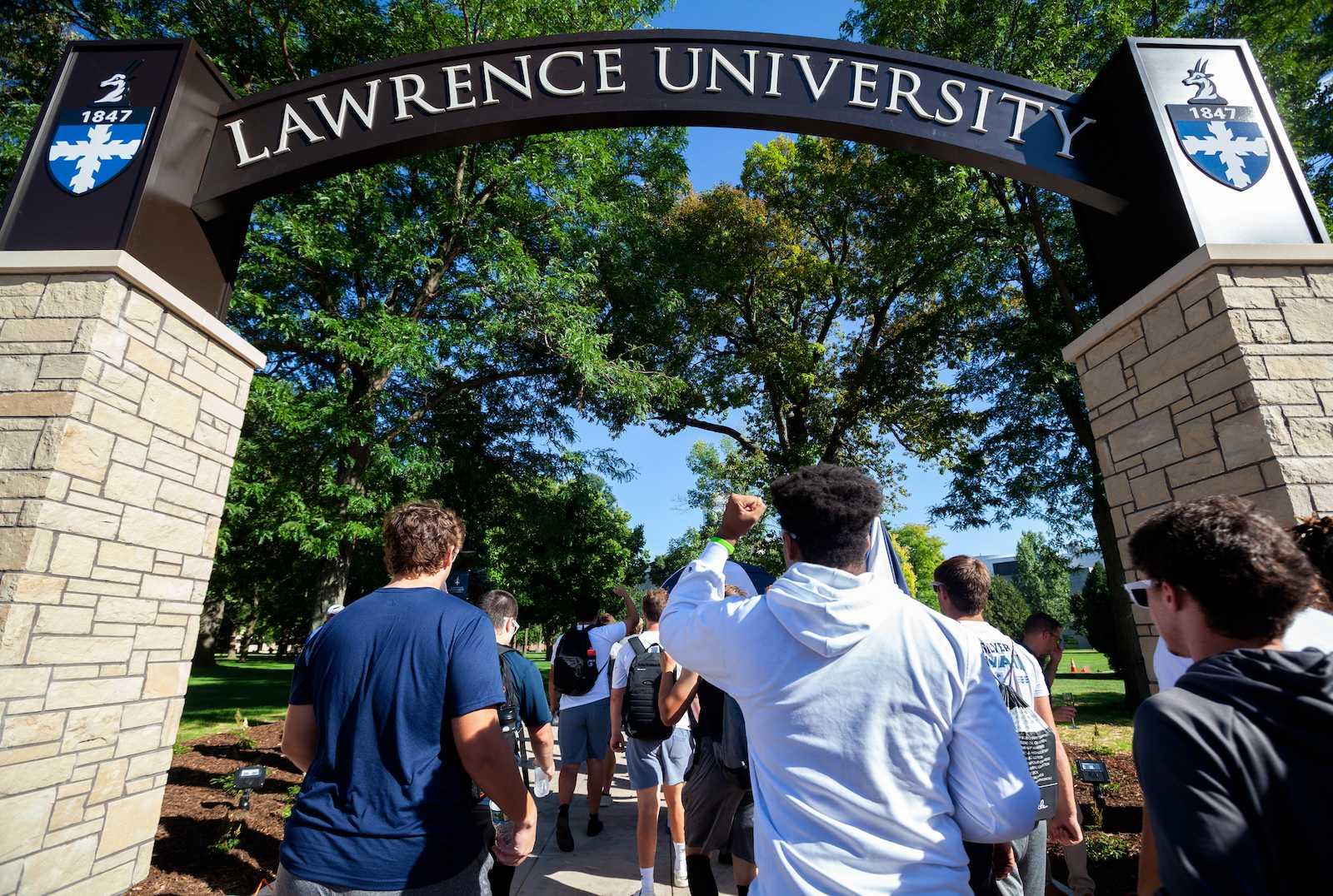 Students walking through arch