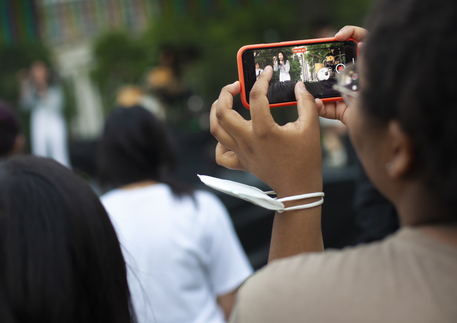 An audience member uses a smart phone to video a performance by Fusion during last year's LUaroo.