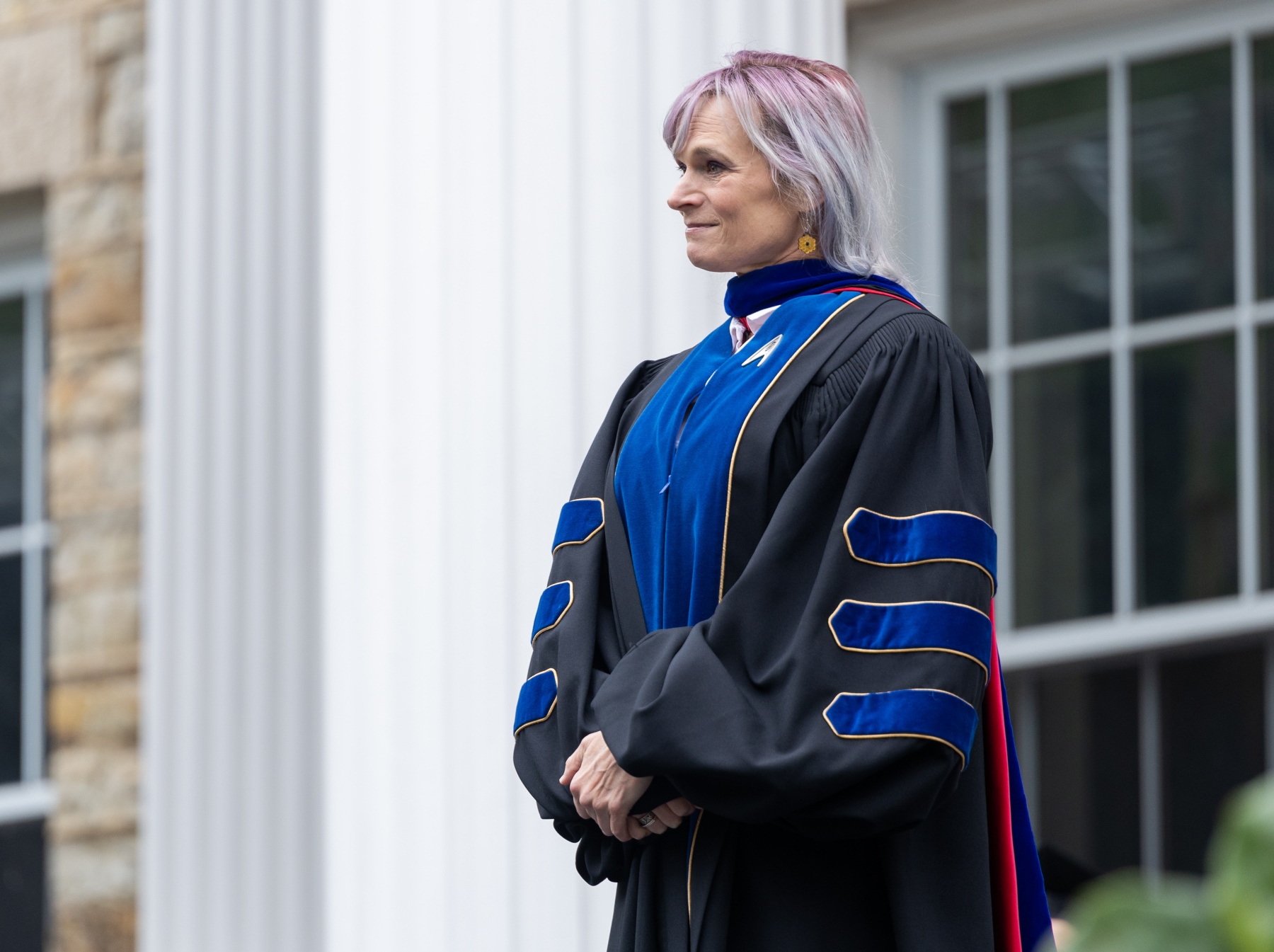 Megan Pickett stands on the Commencement stage as she receives her award.