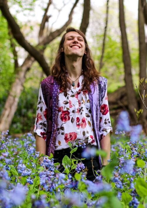 Ada Stelzer stands in a field among flowers.