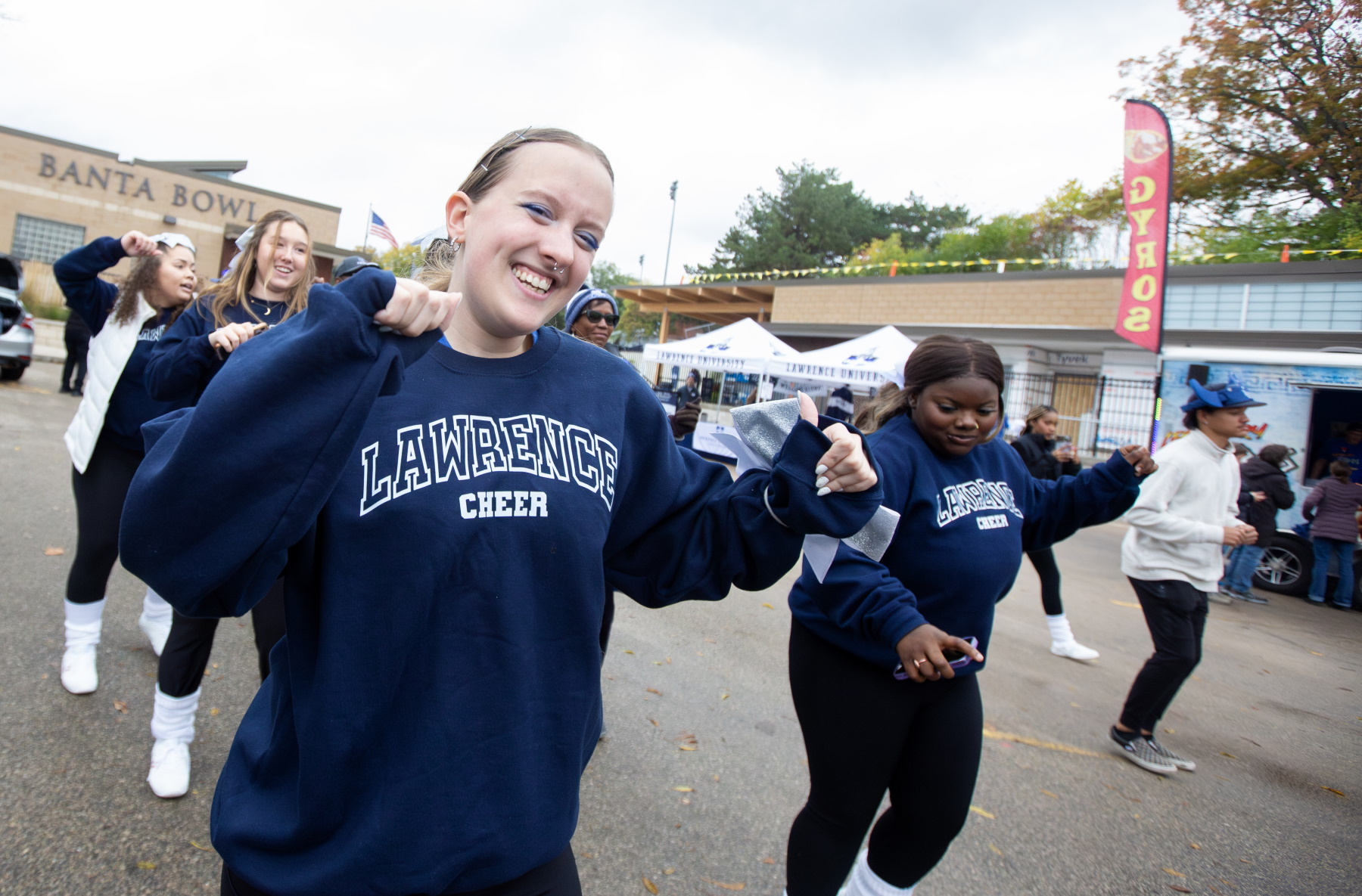 Students dance at the Homecoming tailgate party at Banta Bowl before Saturday's football game.