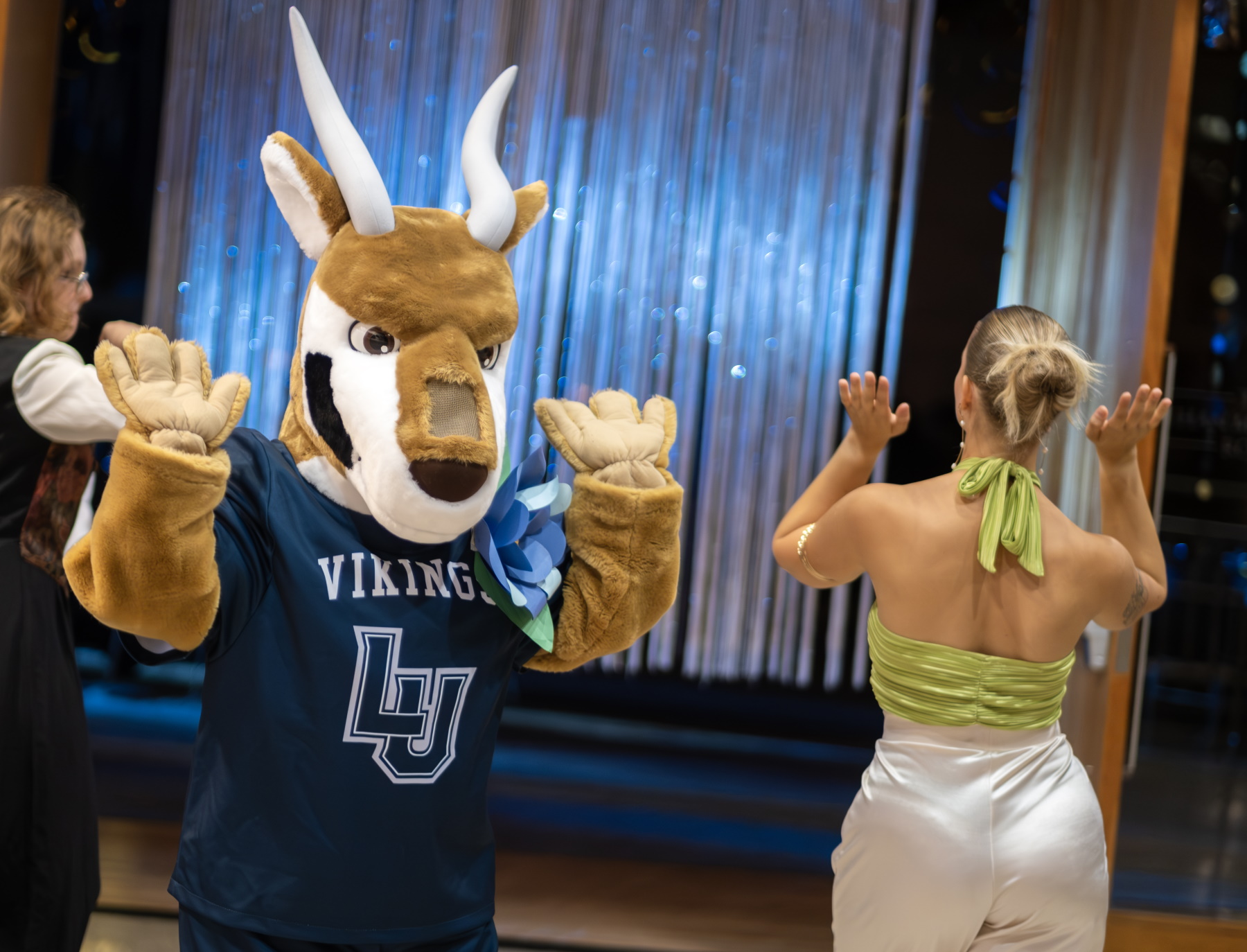 Blu dances with students at the Homecoming dance.