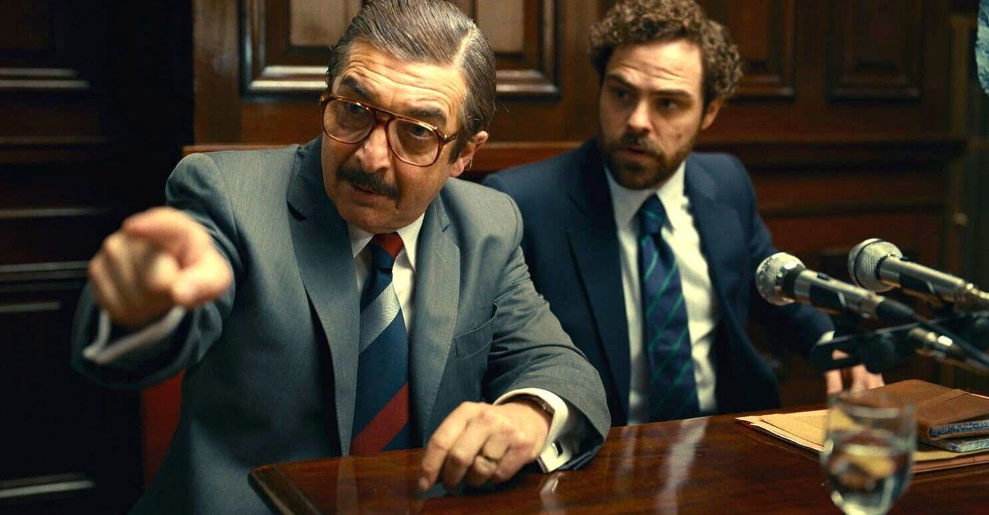 In a still from Argentina, 1985, two men are seen in a courtroom.