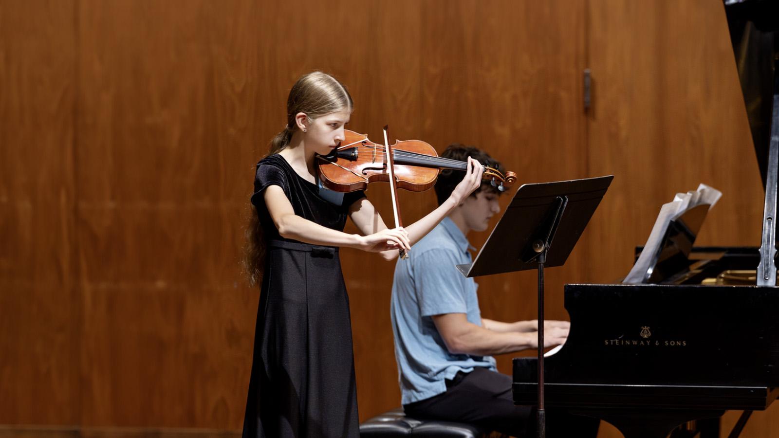 High school students Naomi Peel and Bodhi Pavlik perform on violin and piano at Lawrence University.