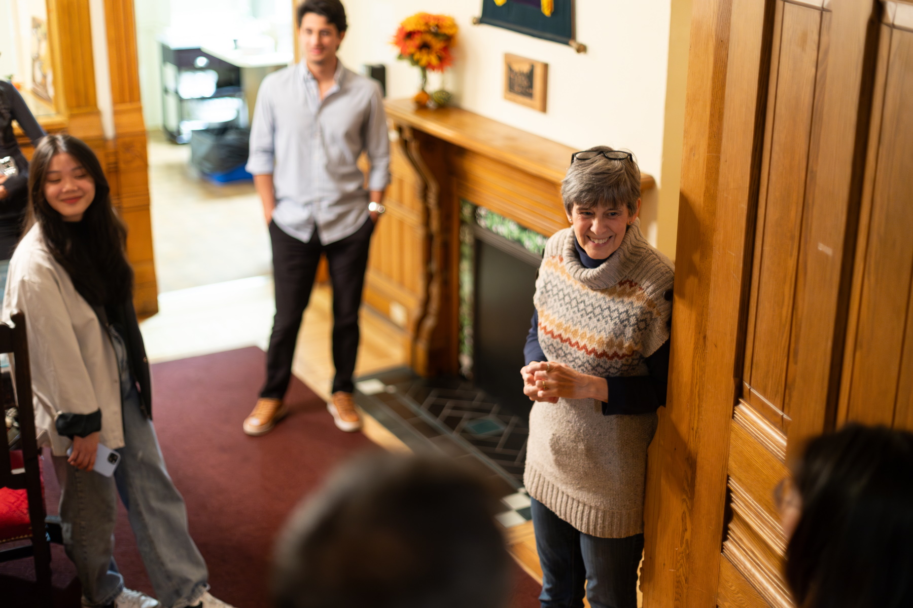 Jill Wilke talks with students in International House. 