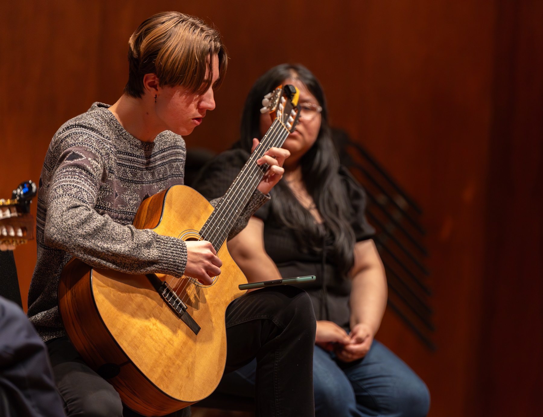 Finn Lee, a first-year student, plays guitar during the songwriting class.