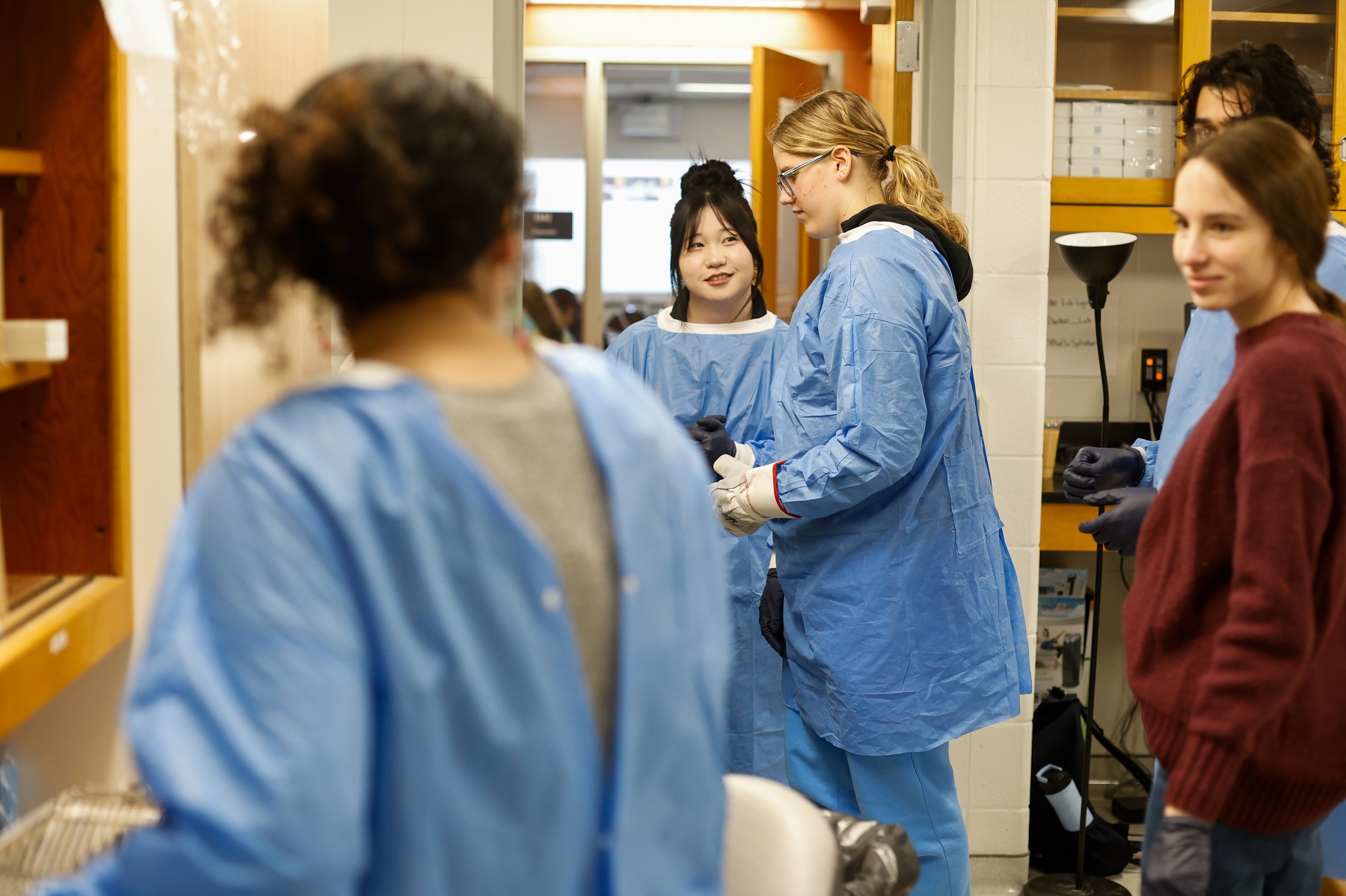 Appleton East students prepare for lab work along with Lawrence students.