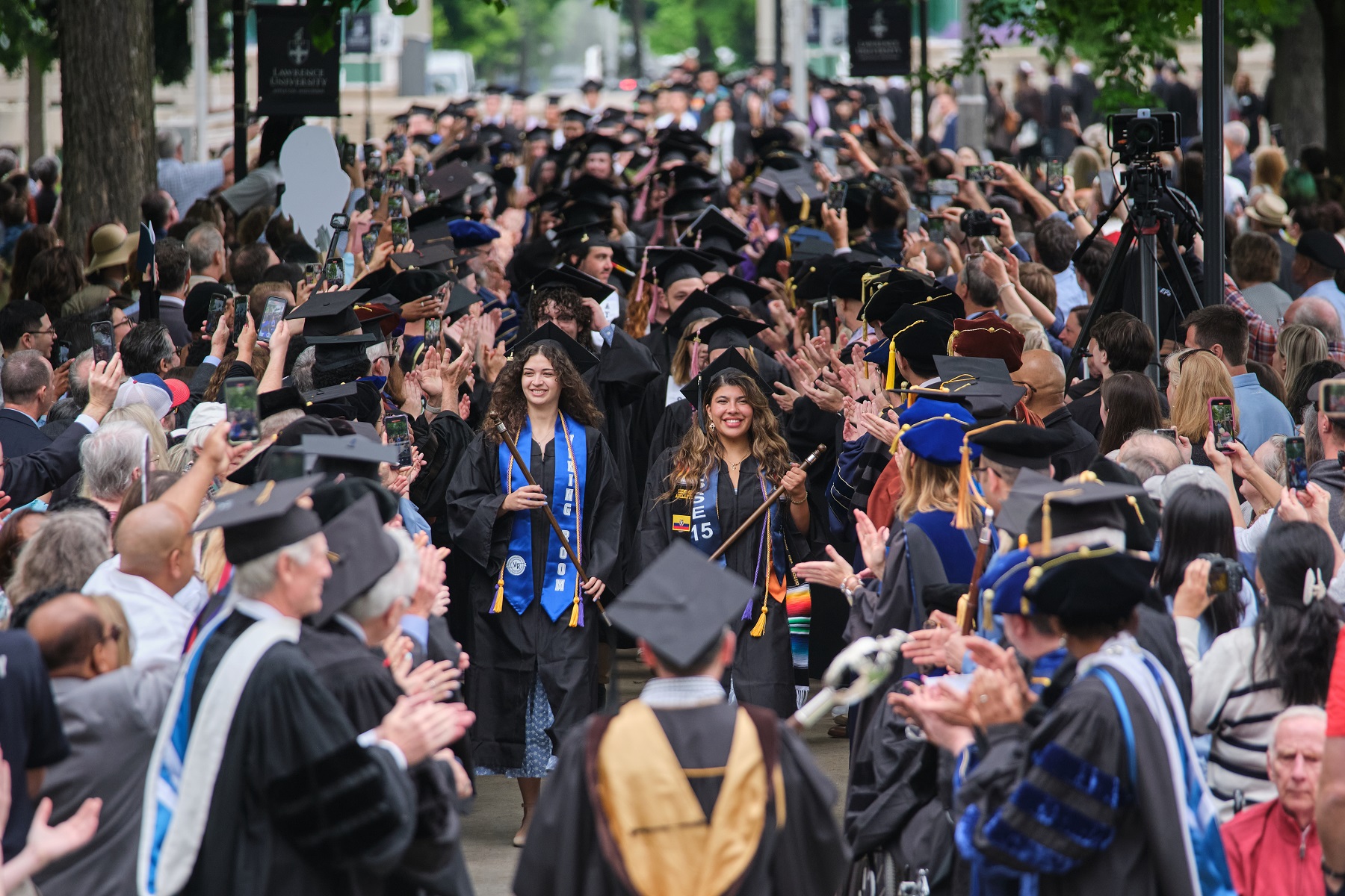 Senior class speaker Bruna Velez (front right) leads the Class of 2025 into Commencement on Main Hall Green.
