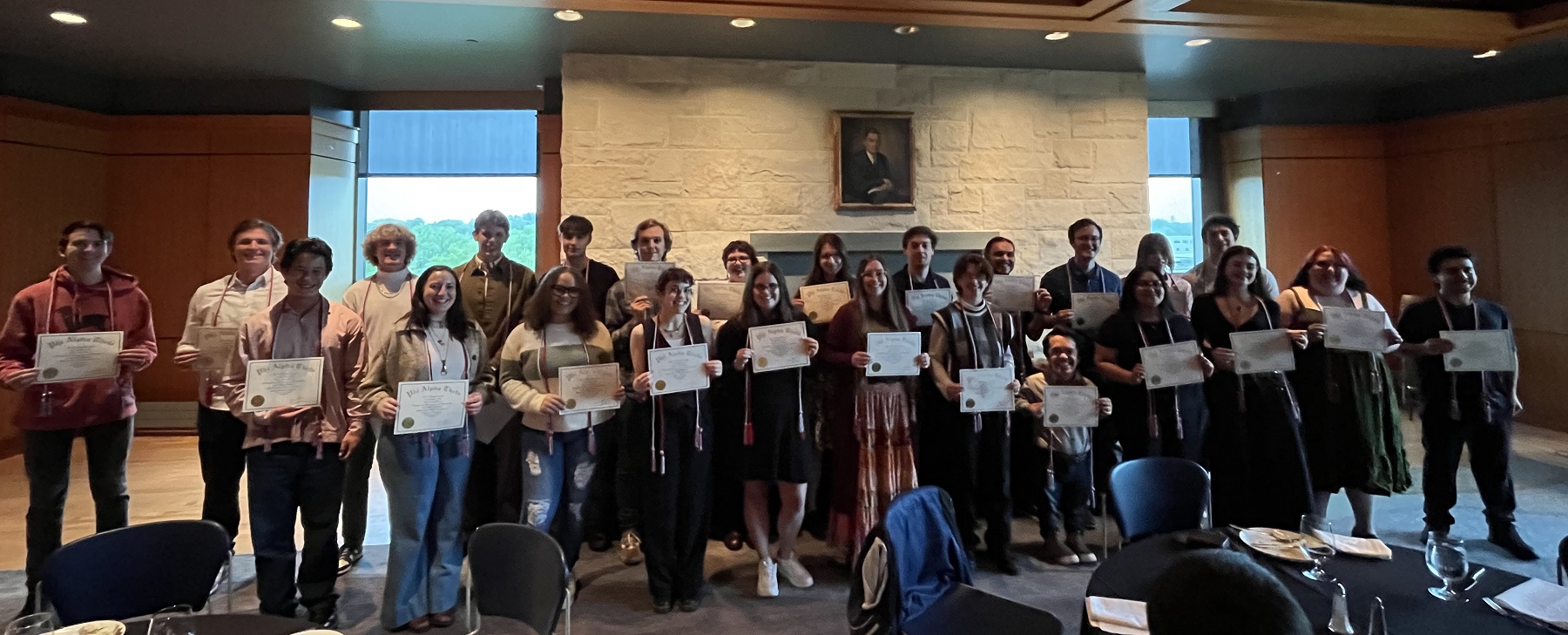 Students pose for a photo after being inducted into the history honor society.