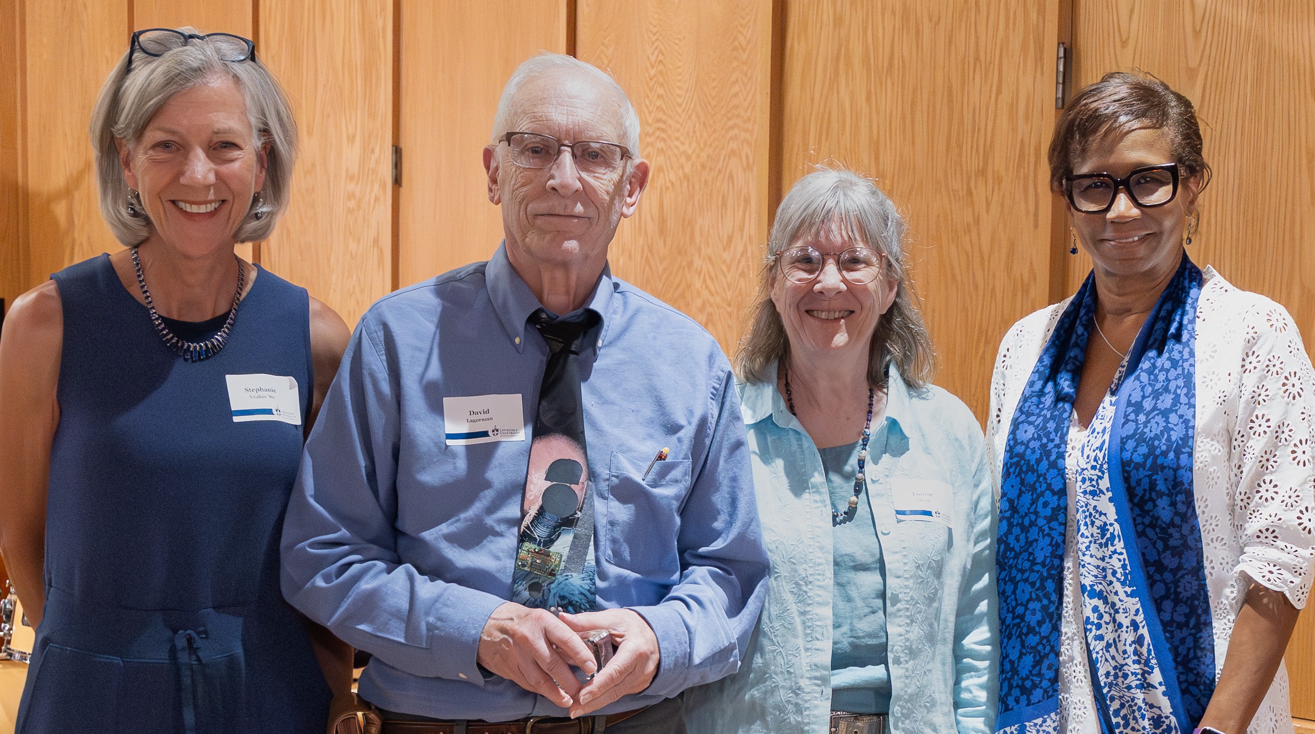 Pictured left to right, Stephanie Vrabec '80, winner of the 2025 Warch Award David Lagermann, Louise Mann, and Lawrence University President Laurie Carter