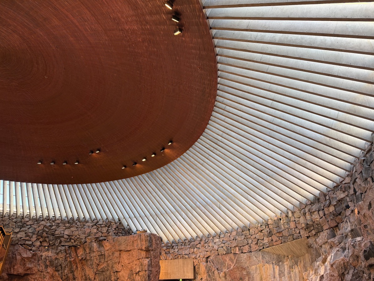 Interior of Temppeliaukio Church, with its circular copper ceiling and stone walls.