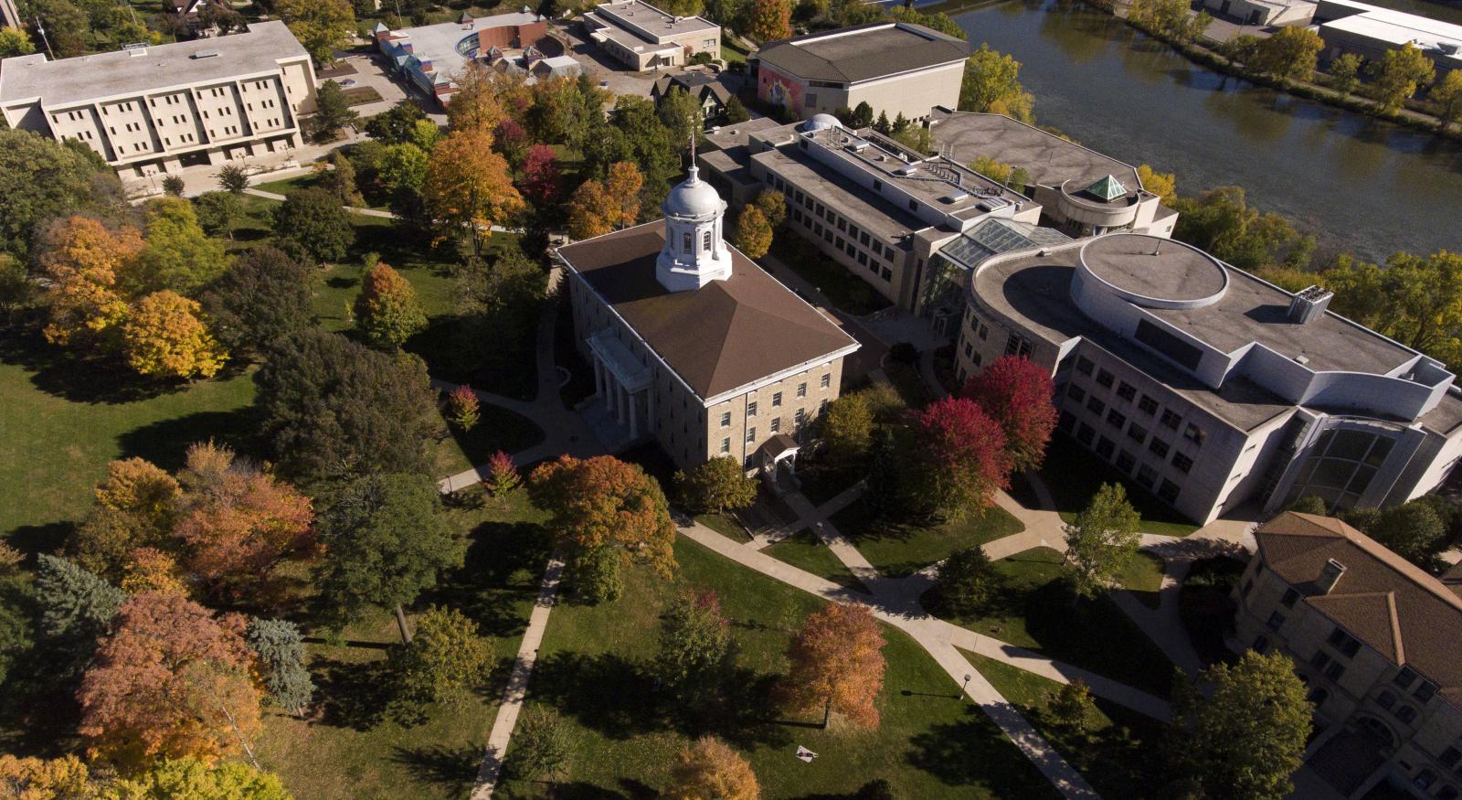 fall aerial campus view showing Main Hall, and buildings to south and east of that with brilliant fall colors