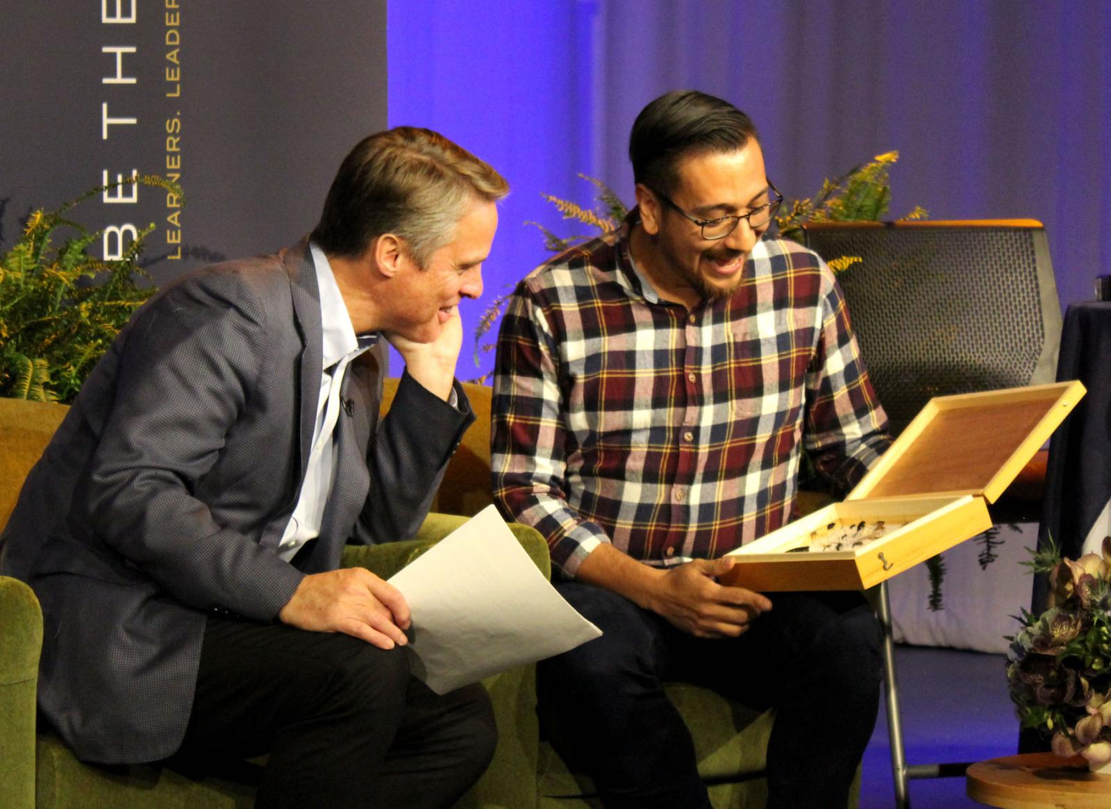 Terry Moran ’82 (left) shares a moment with biology professor Israel Del Toro during the 2019 Giving Day 