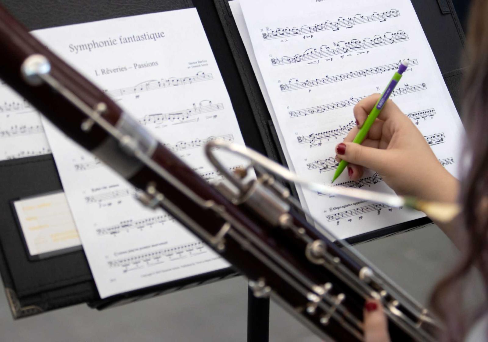 Student writing on sheet music during Viking Bassoon Ensemble rehearsals.