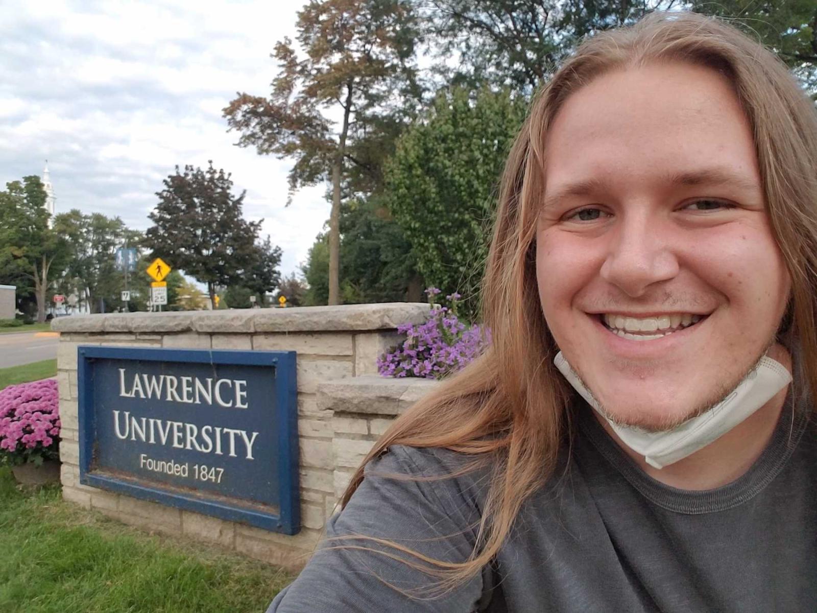Harris Marks poses in front of a Lawrence University sign.