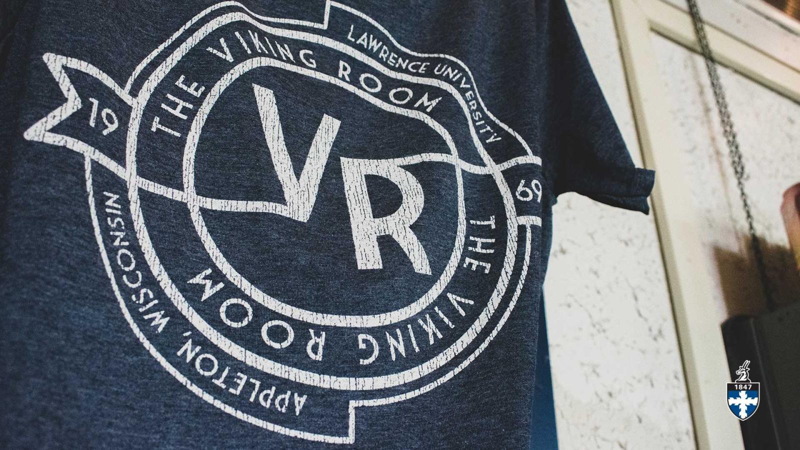 Close up of blue t-shirt that says, "The Viking Room".