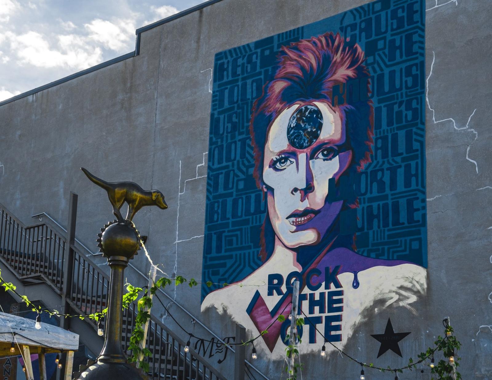 mural of a man with the words "rock the vote" on his chest