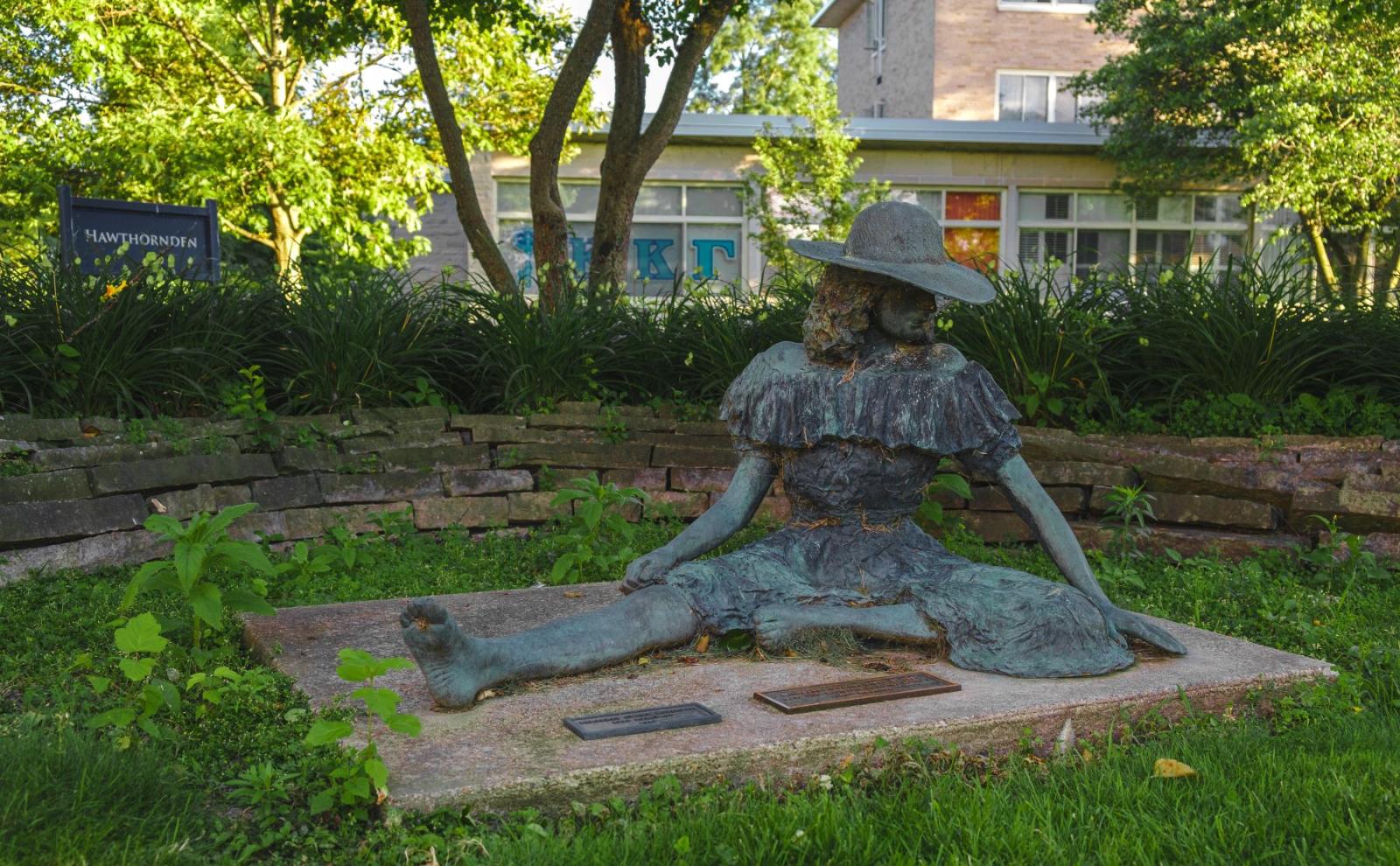 Sculpture of a woman sitting in the grass