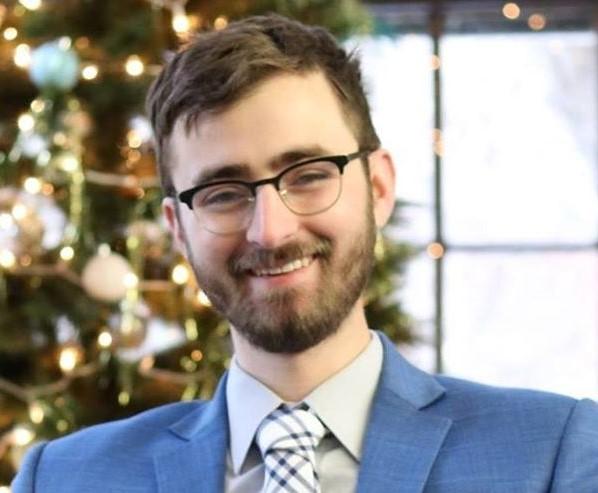 Luther Abel '22 smiling in a blue suit