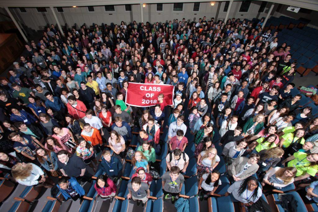 Class of 2018 posing with their class flag in the chapel