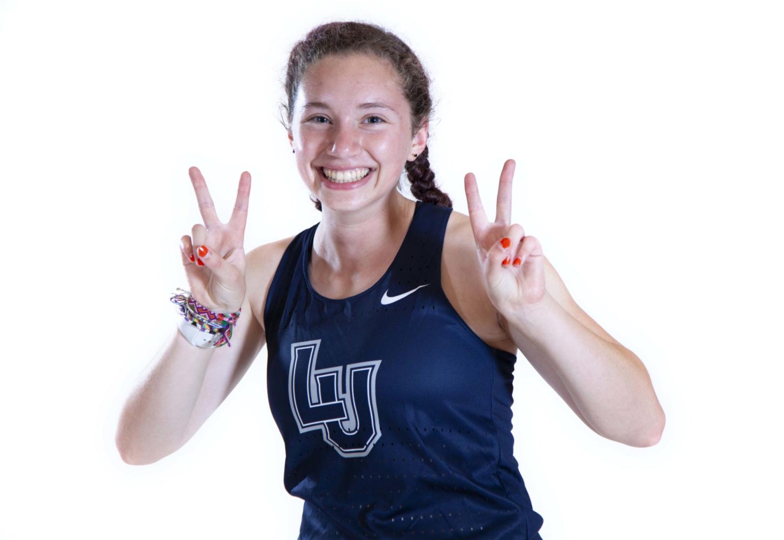 Cross Country runner Althea Foster hold up peace signs