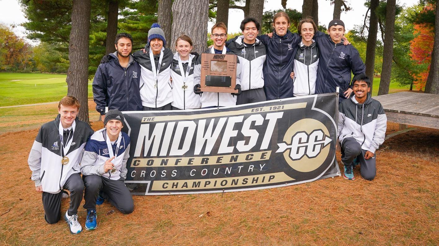 Cross Country men's team posing around large sign that reads "Midwest Conference Cross Country Championship"