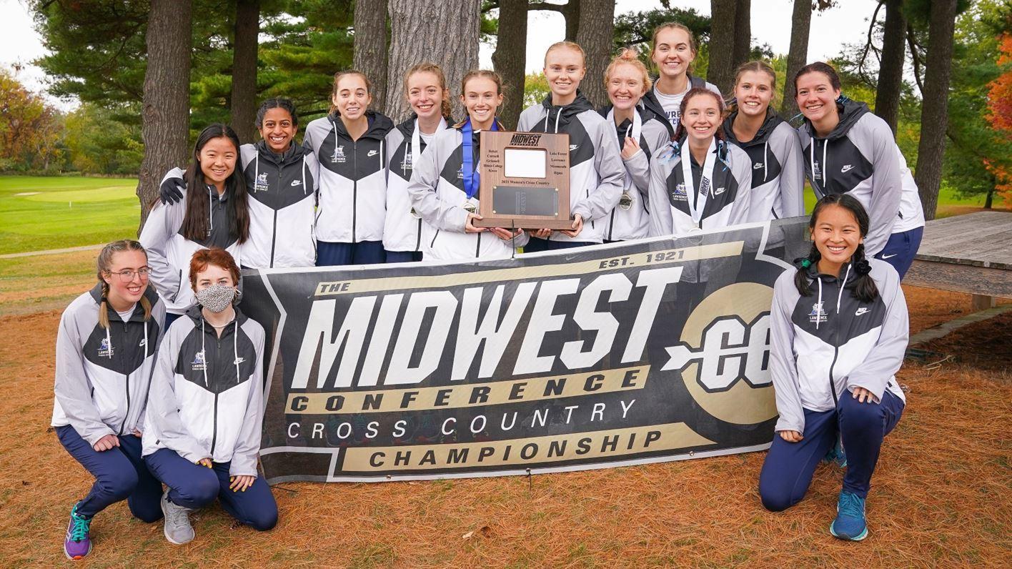 Women's cross country team poses around sign that says: Midwest Conference Cross Country Championship