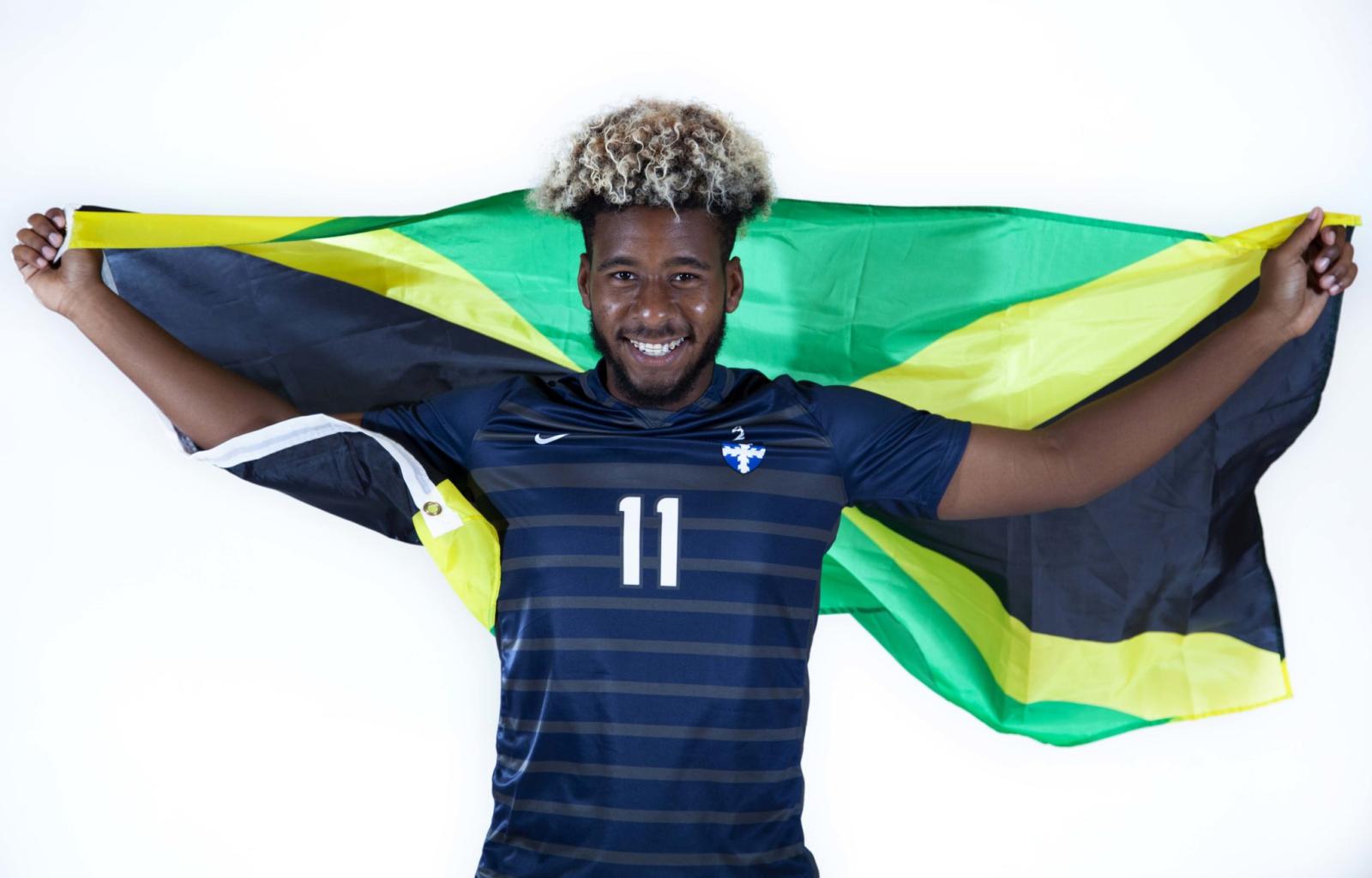 Soccer player Mark Todd holds Brazilian flag