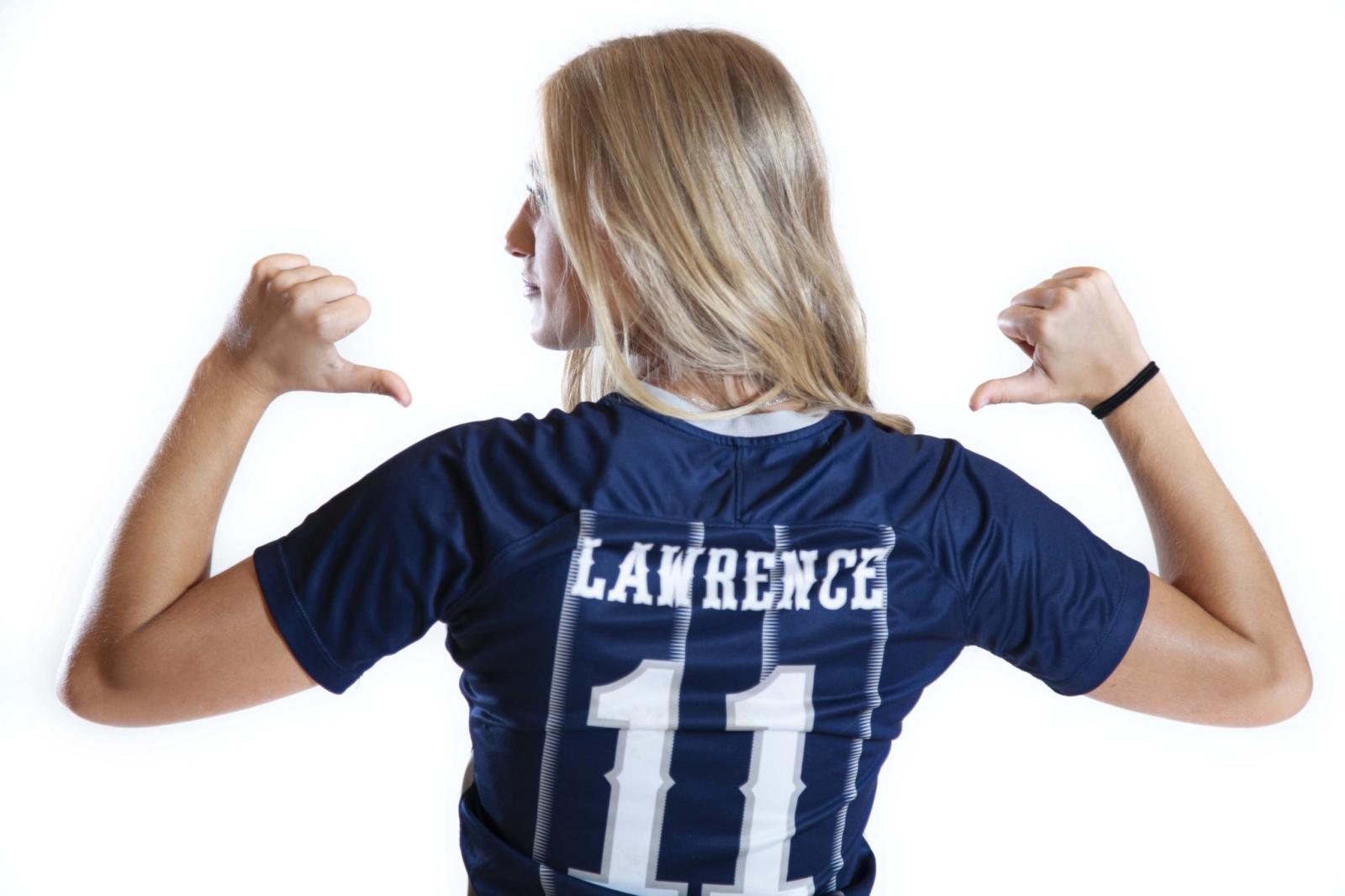 Soccer player Cambrie Rickard points to the back of her jersey