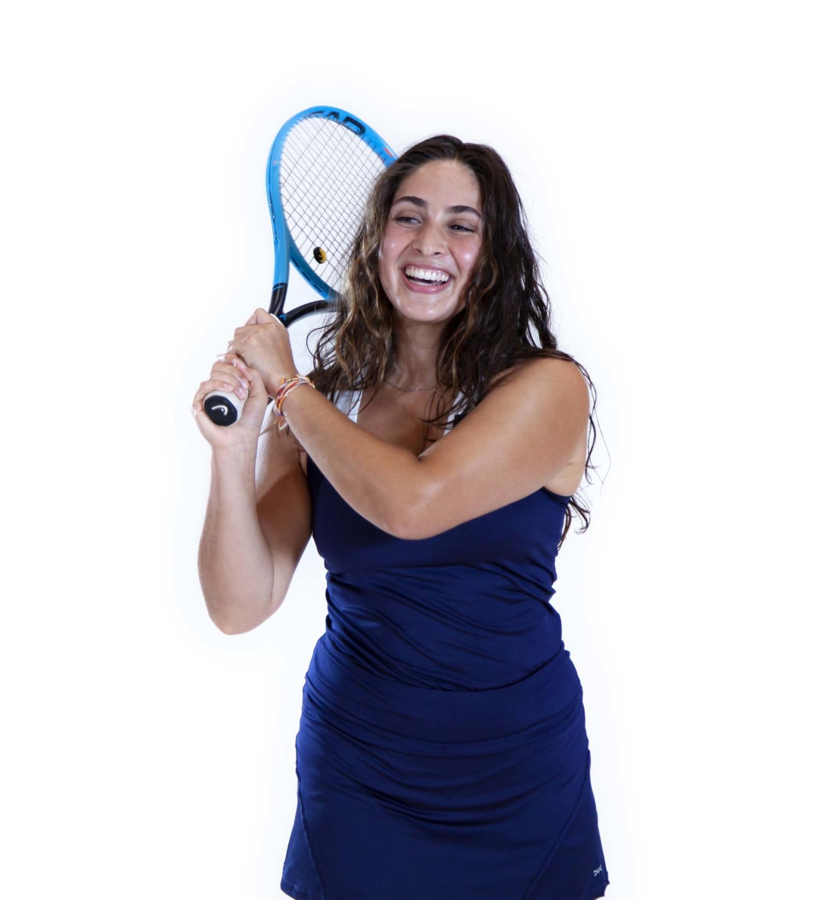 Tennis player Lauren Aturaliya holds her racket, ready to swing