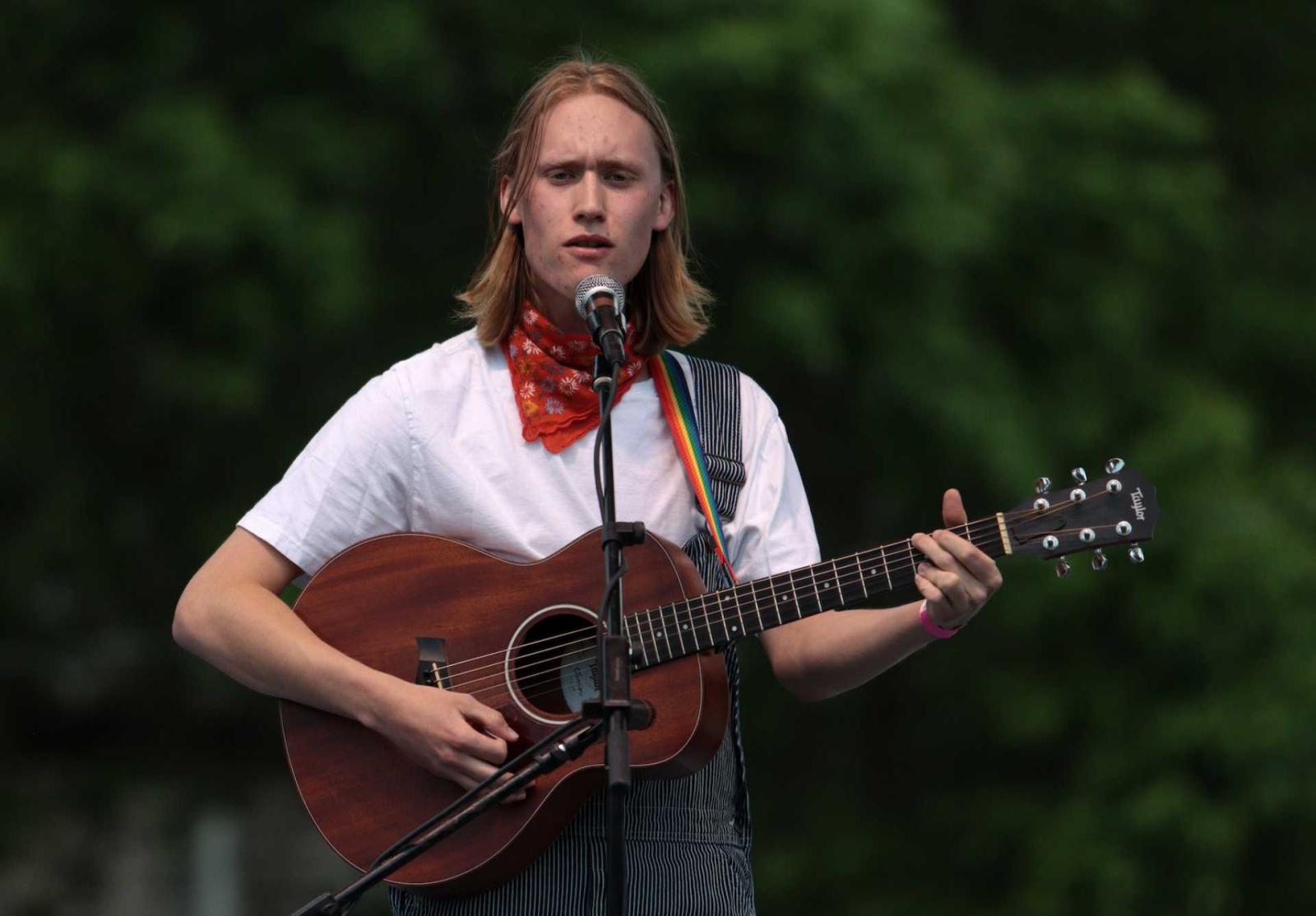 Student, Evan Snoey, playing guitar onstage