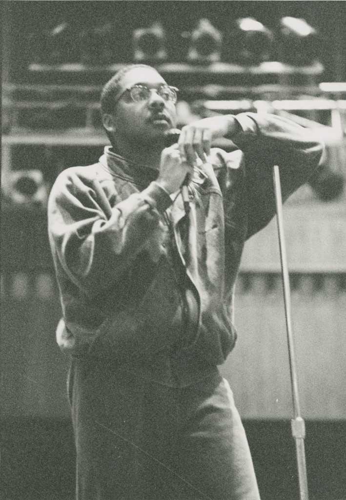 Wynton Marsalis leans on the microphone stand as he talks with students during his 1988 visit to Lawrence.