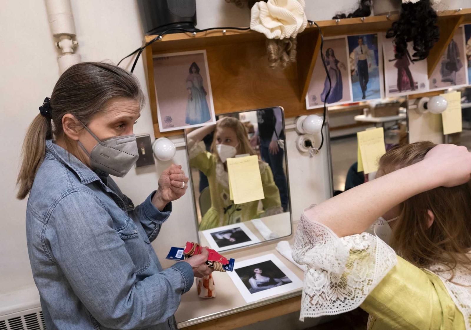 Karin Simonson Kopischke, instructor of Theatre Arts and costume shop supervisor, talks with Anna Dlugi, a first-year, in preparation for hair and makeup before rehearsal.